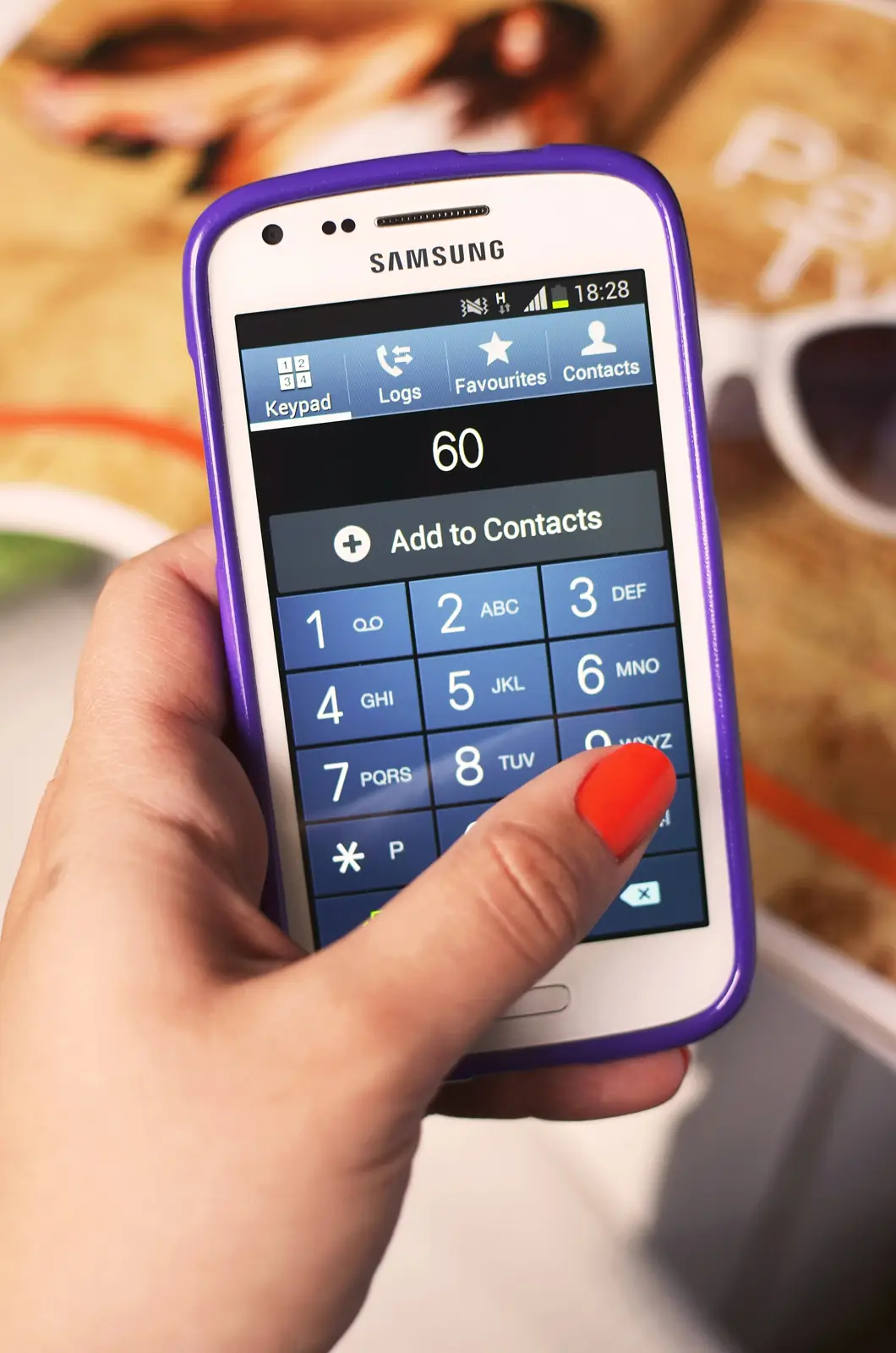 A hand holding an Android phone